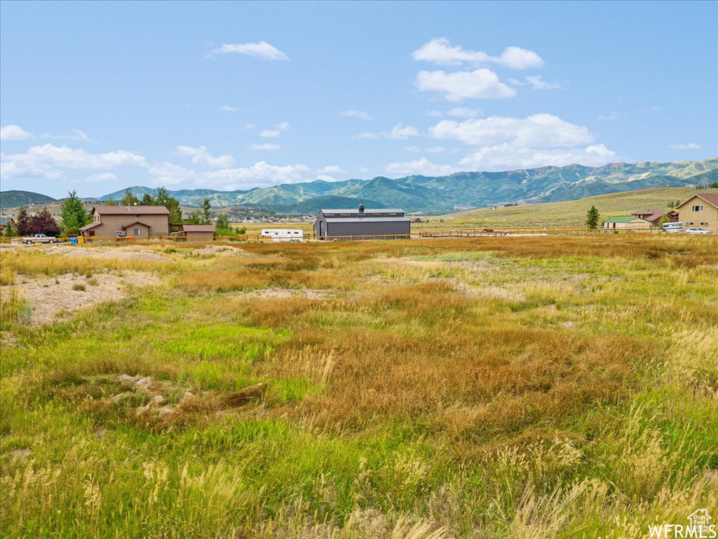 View of mountain backdrop featuring rural landscape