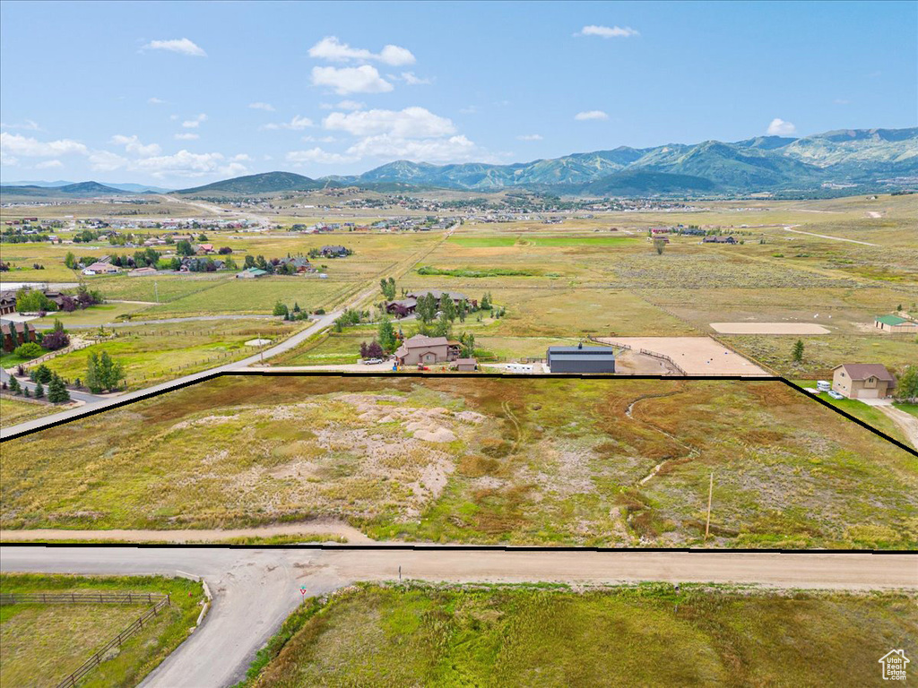 Overview of rural landscape featuring property boundaries highlighted and a mountainous background