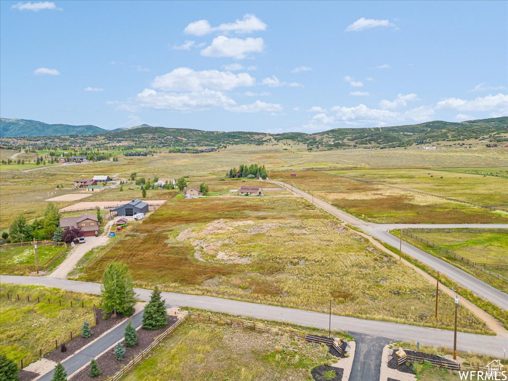 Overview of rural landscape featuring a mountain backdrop