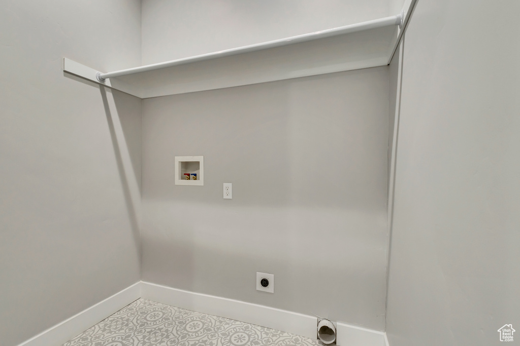 Laundry room with hookup for a washing machine, baseboards, hookup for an electric dryer, and tile patterned flooring