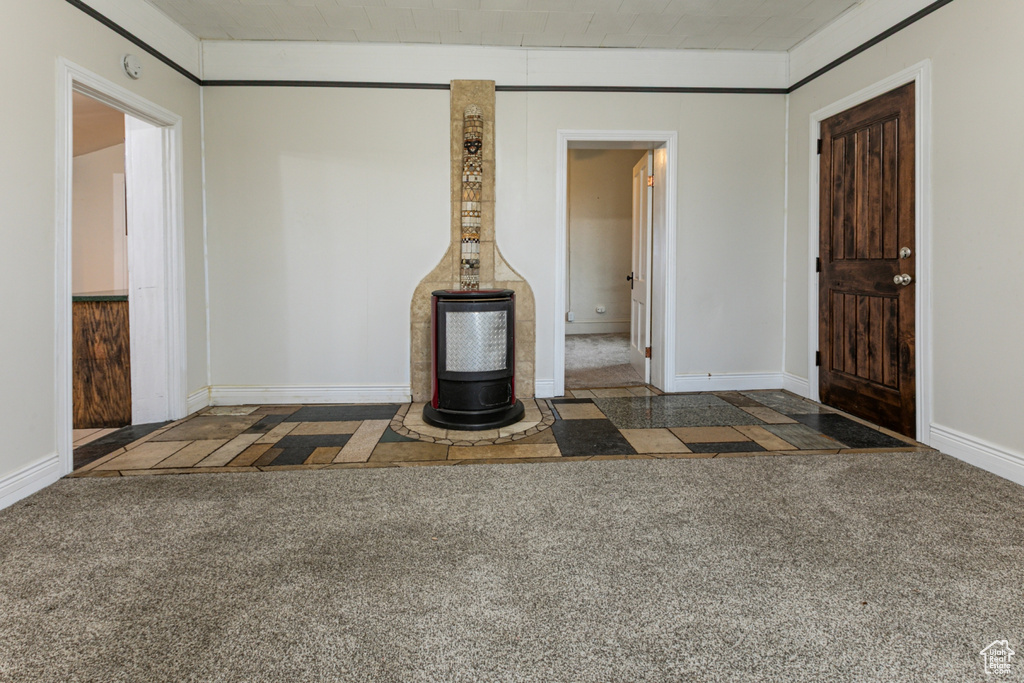 Unfurnished living room featuring carpet floors and baseboards