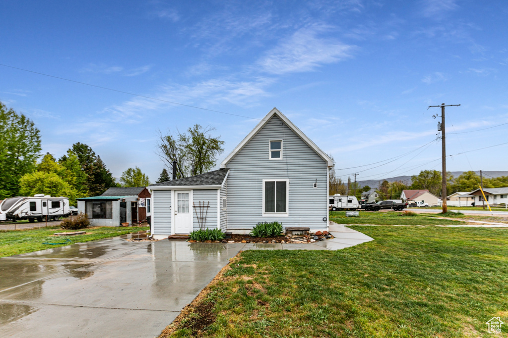 View of front of house featuring a front yard and roof with shingles