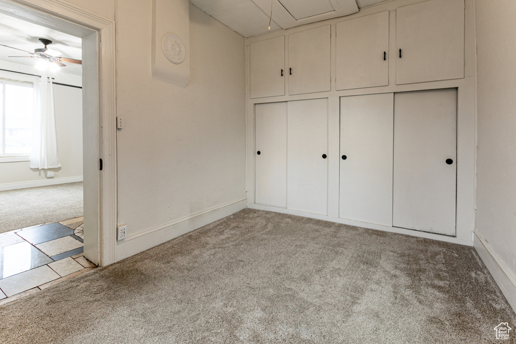 Unfurnished bedroom with carpet floors and baseboards