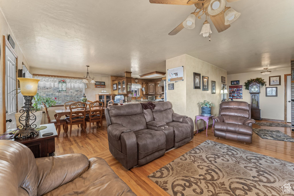Living room with ceiling fan and wood finished floors
