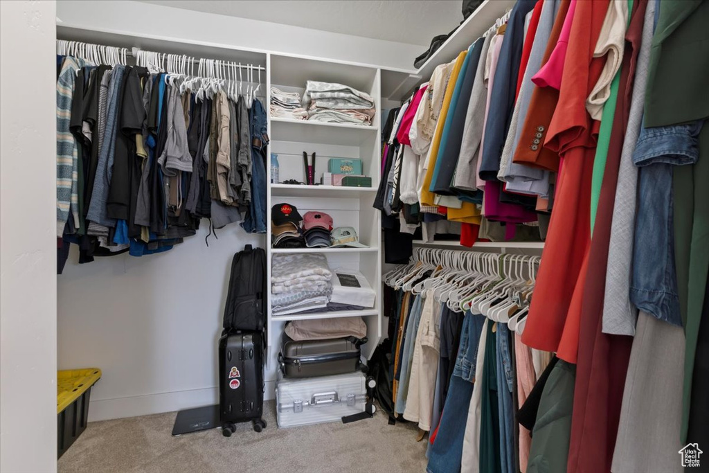 Walk in closet with carpet floors