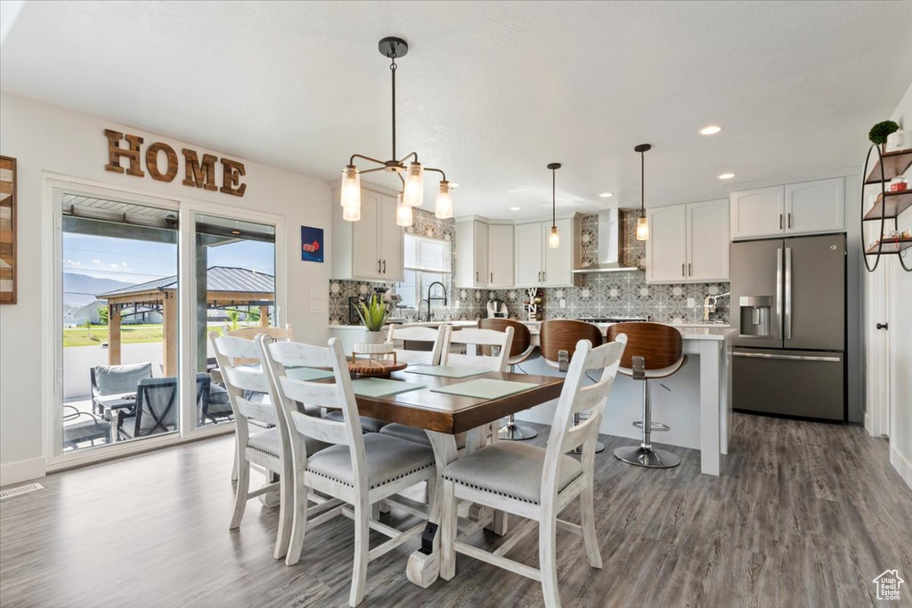 Dining area with wood finished floors, recessed lighting, and baseboards