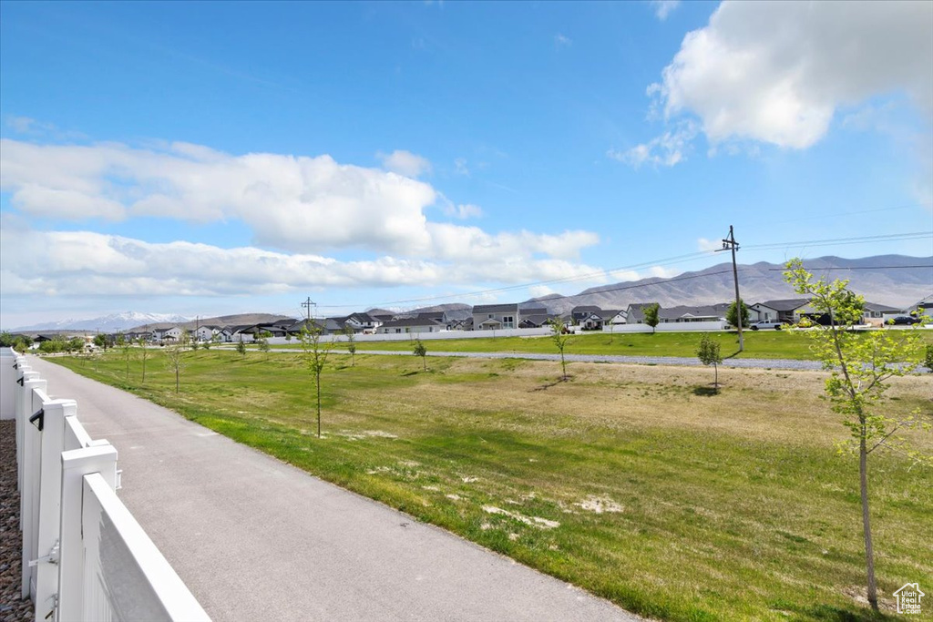 View of asphalt road featuring a mountain view and a residential view