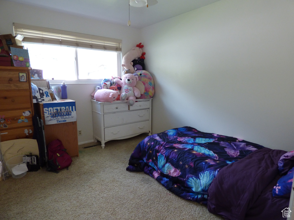 Carpeted bedroom with ceiling fan