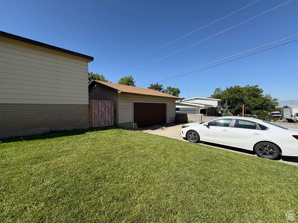 View of yard featuring a garage and an outdoor structure
