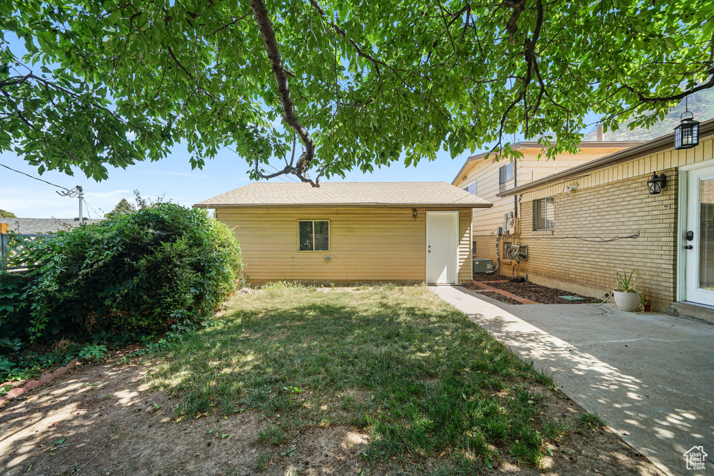 Rear view of house featuring a yard and a patio