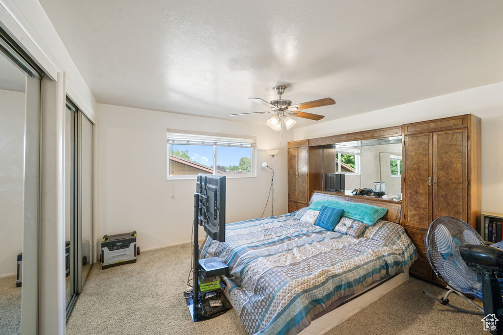 Bedroom featuring carpet floors, a closet, and a ceiling fan