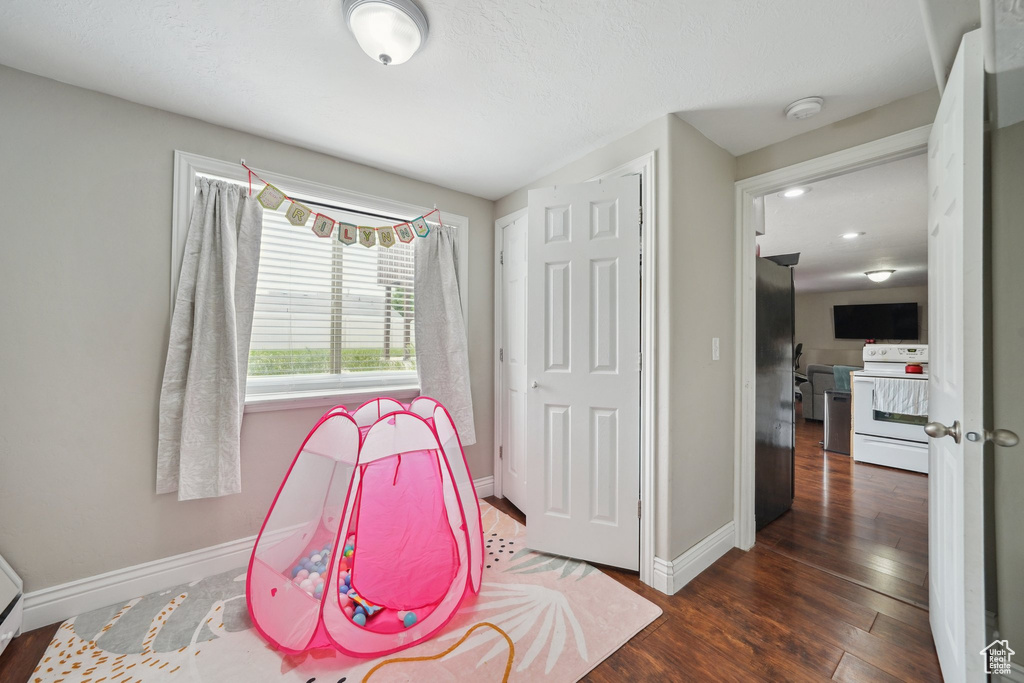 Rec room with baseboards and wood finished floors