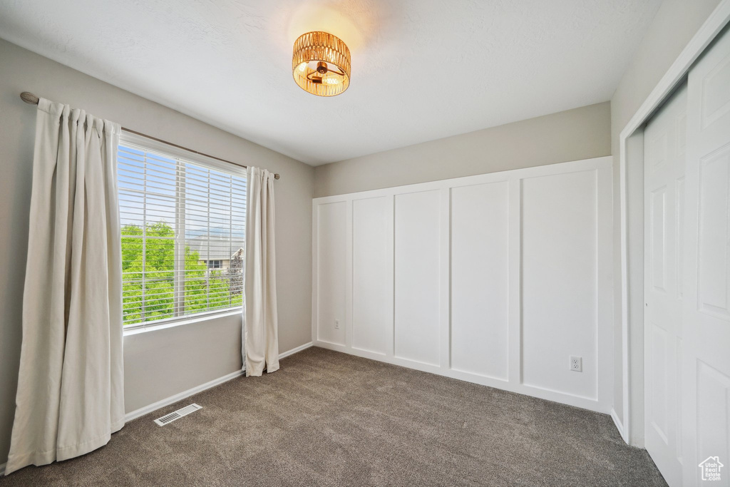 Unfurnished bedroom with carpet and baseboards