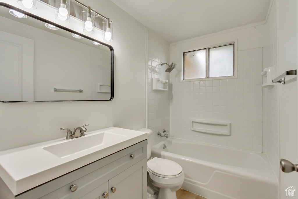 Bathroom featuring toilet, vanity, and shower / bathtub combination