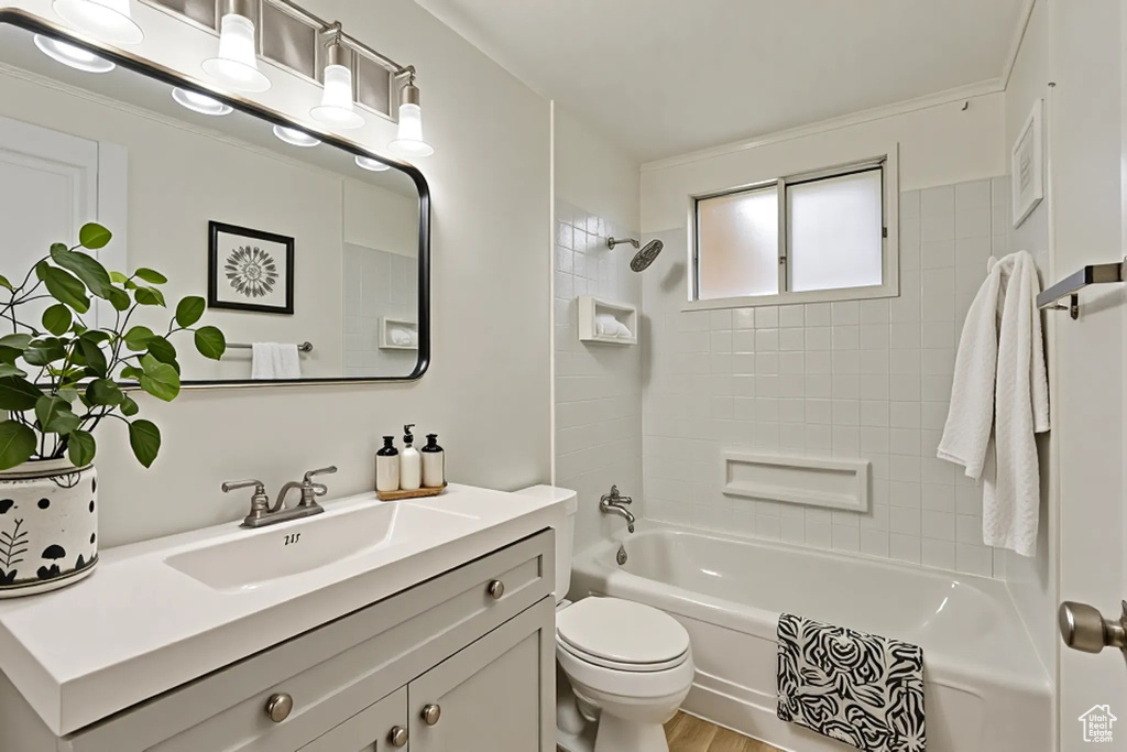 Bathroom featuring vanity, toilet, and shower / washtub combination