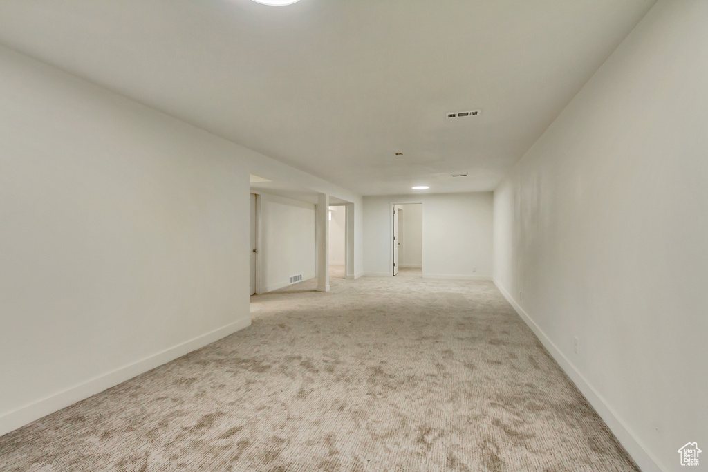 Unfurnished room with light carpet and baseboards