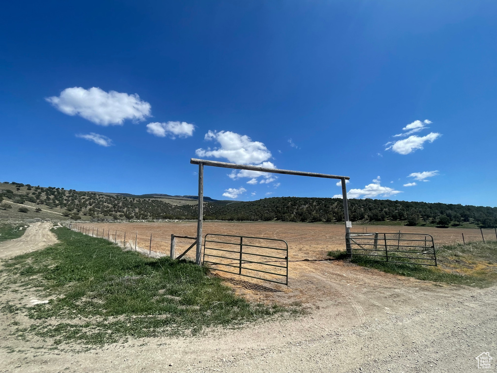View of street with a view of countryside and a gated entry