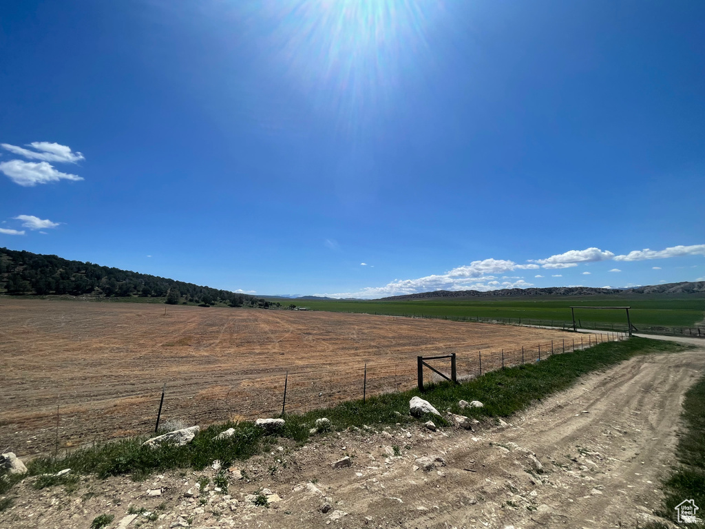 View of yard featuring a view of rural / pastoral area and fence