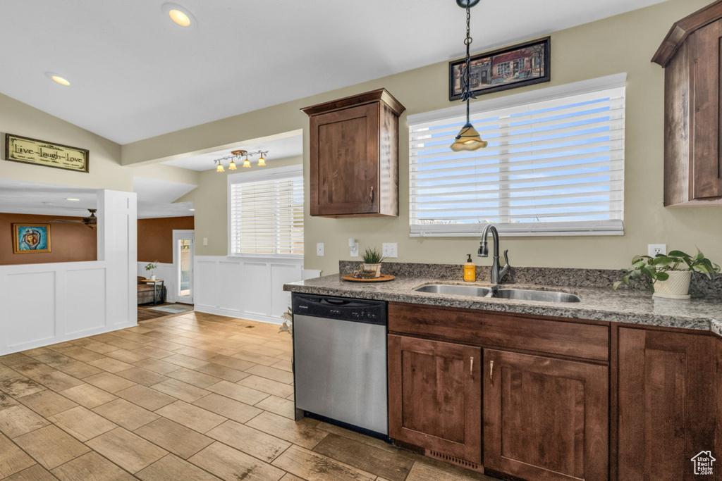 Kitchen featuring stainless steel dishwasher, a sink, pendant lighting, dark brown cabinetry, and recessed lighting