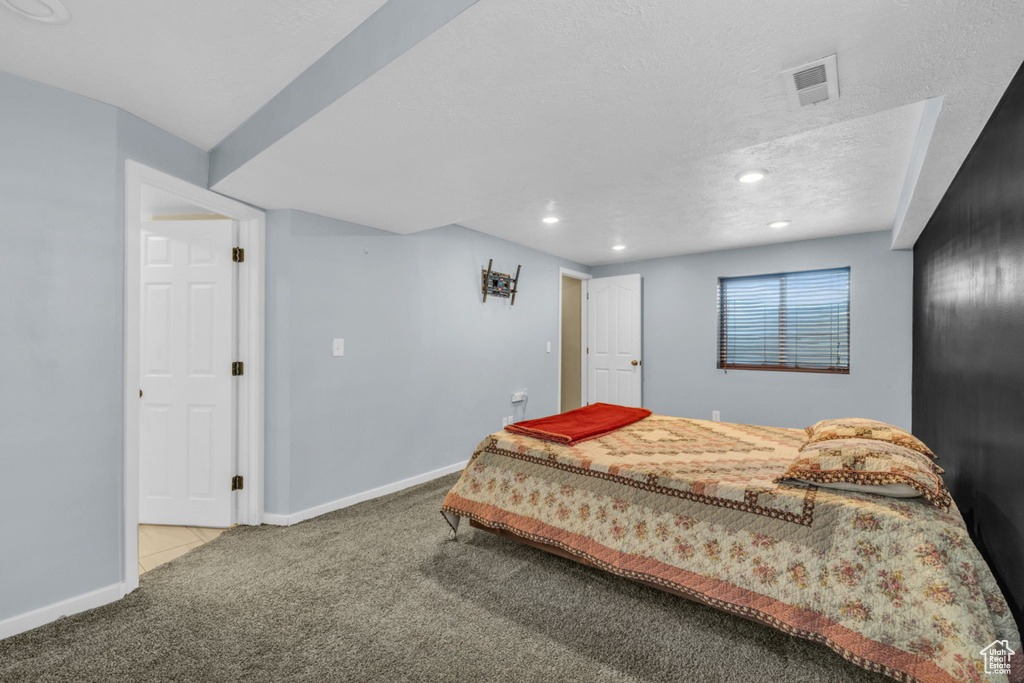 Bedroom with carpet floors, baseboards, recessed lighting, and a textured ceiling
