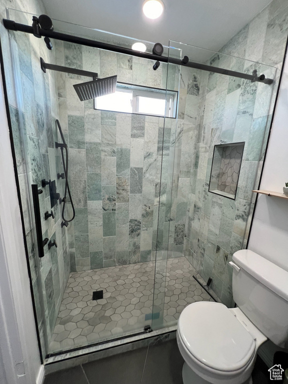 Full bath featuring toilet and a shower stall