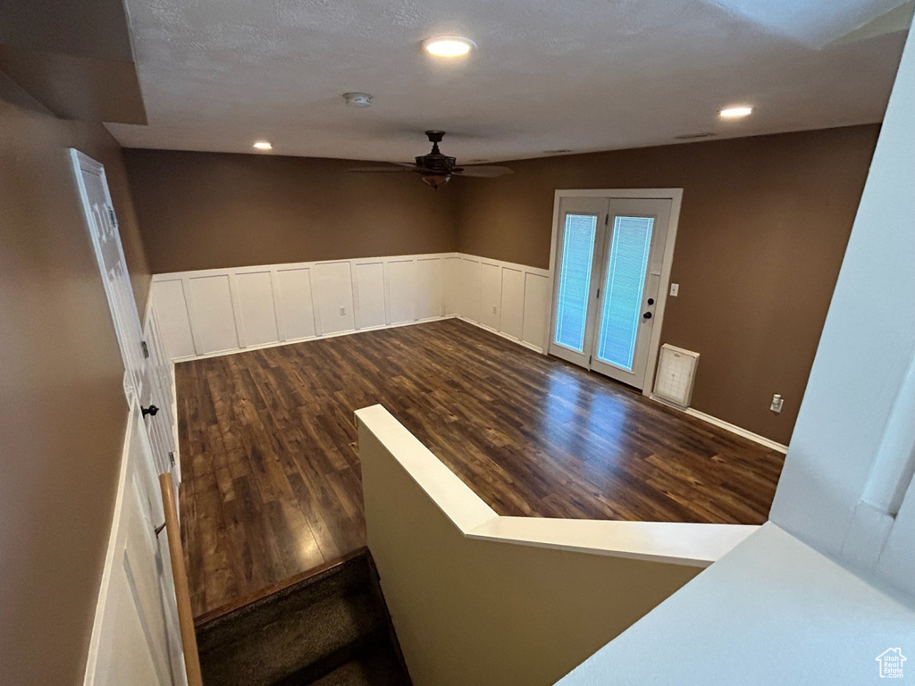 Spare room featuring ceiling fan, wood finished floors, recessed lighting, and a wainscoted wall