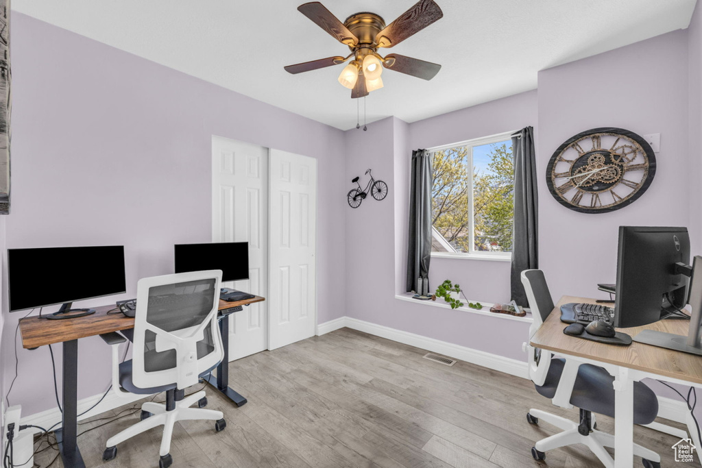 Office area with baseboards, wood finished floors, and ceiling fan