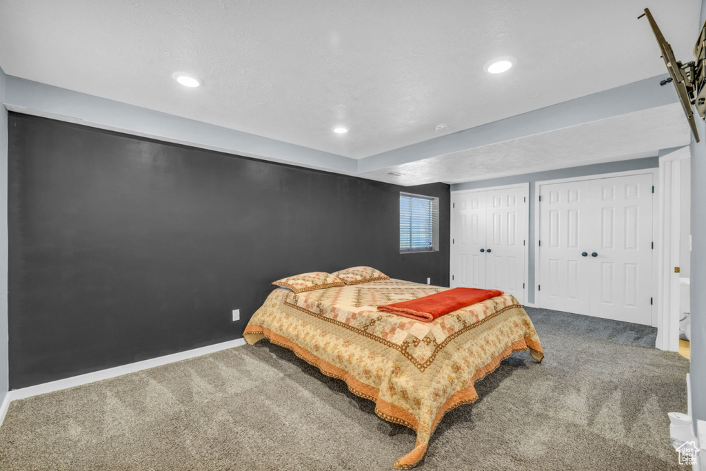 Bedroom with carpet floors, multiple closets, recessed lighting, and baseboards