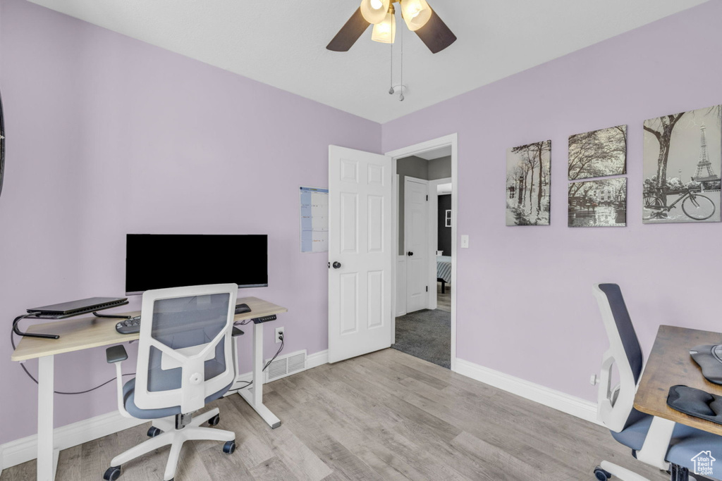 Office area featuring ceiling fan, light wood-style floors, and baseboards