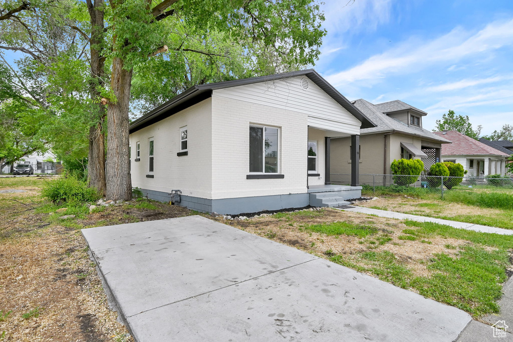 View of front of property featuring brick siding and fence