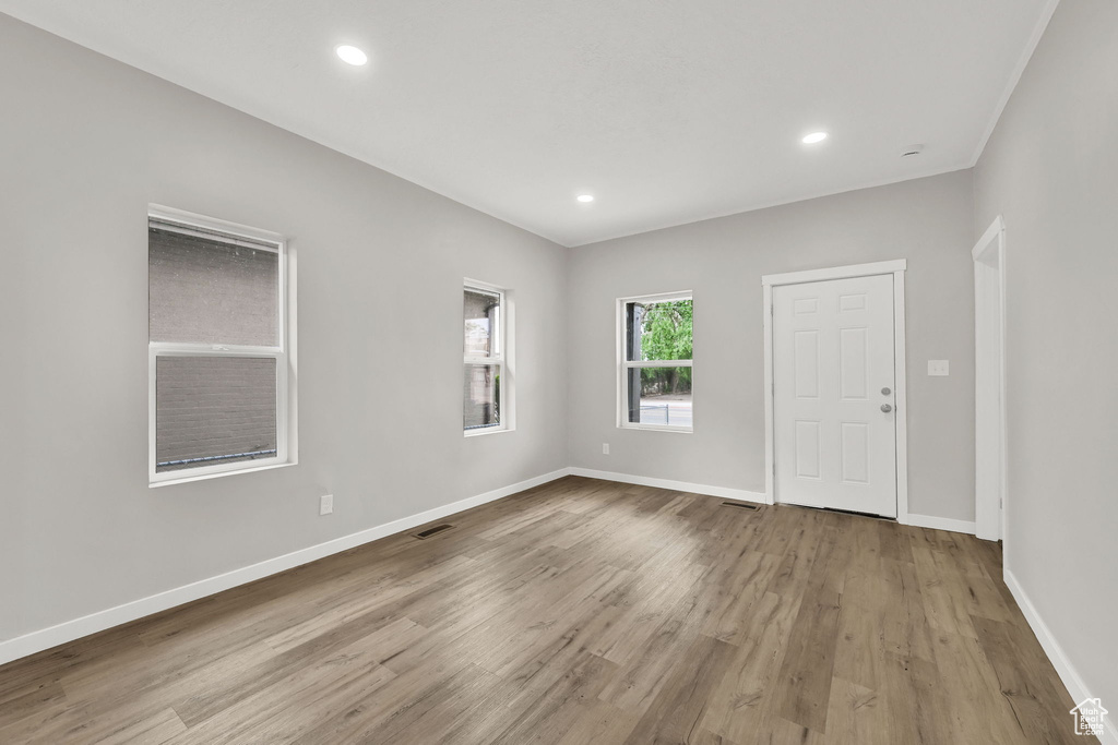 Empty room with wood finished floors, baseboards, and recessed lighting