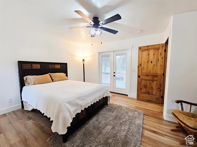 Bedroom with access to outside, french doors, light wood-style floors, baseboards, and ceiling fan