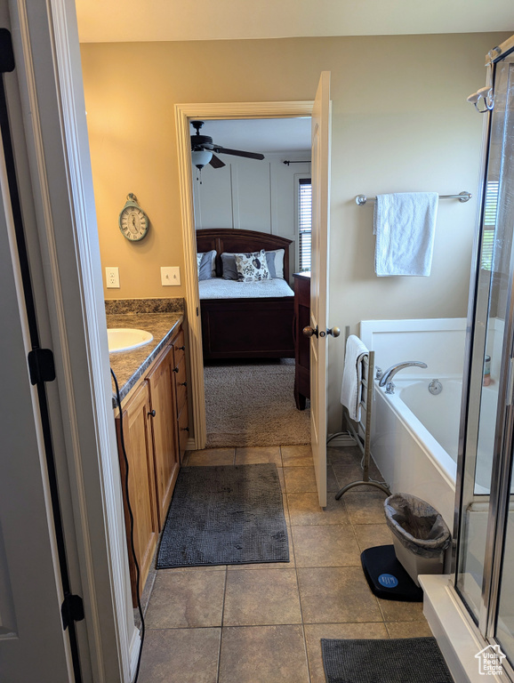 Full bathroom featuring vanity, healthy amount of natural light, connected bathroom, and ceiling fan