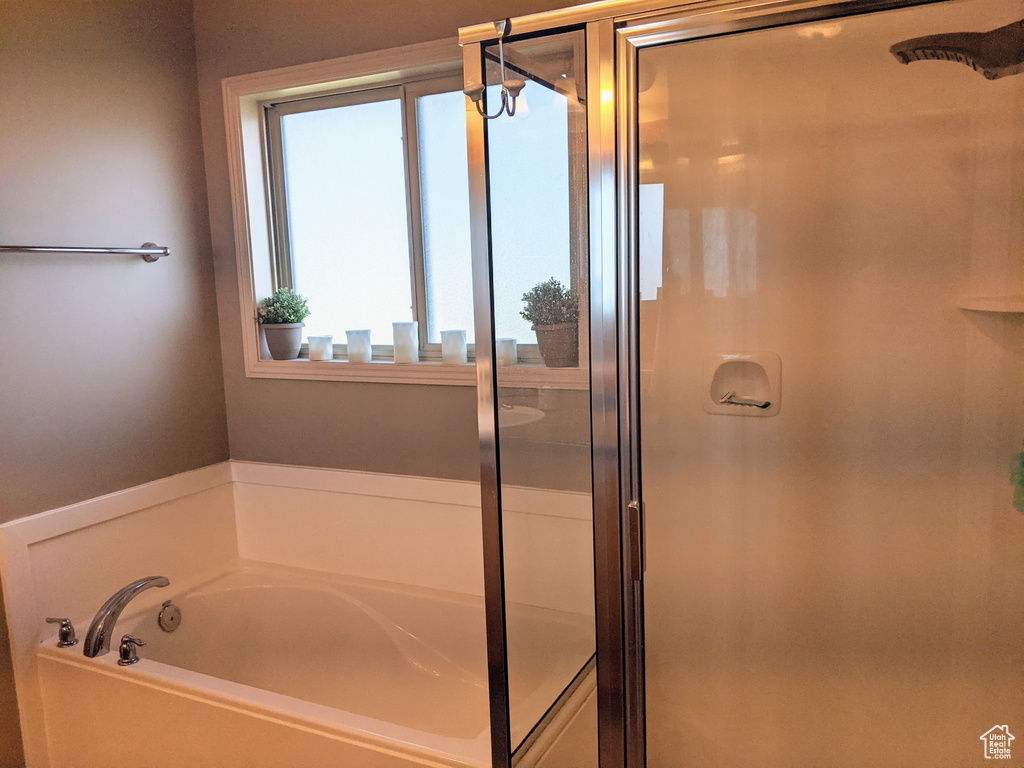Full bathroom featuring a shower stall and a garden tub