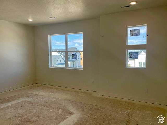 Spare room featuring baseboards and recessed lighting