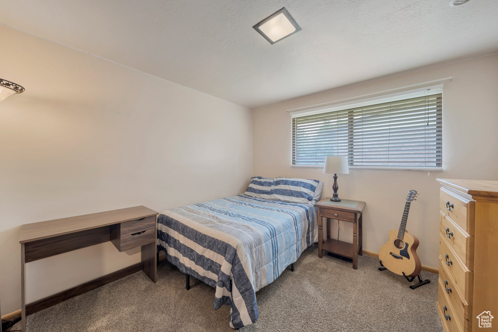 Carpeted bedroom featuring baseboards