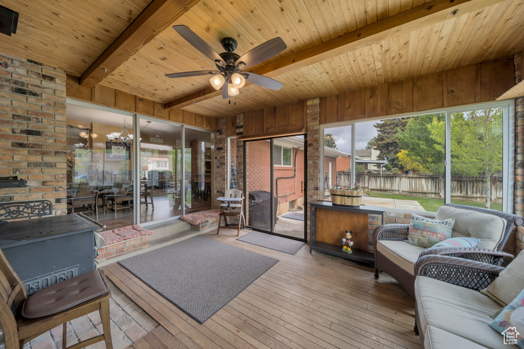 Sunroom with an outdoor hangout area, beamed ceiling, and a ceiling fan
