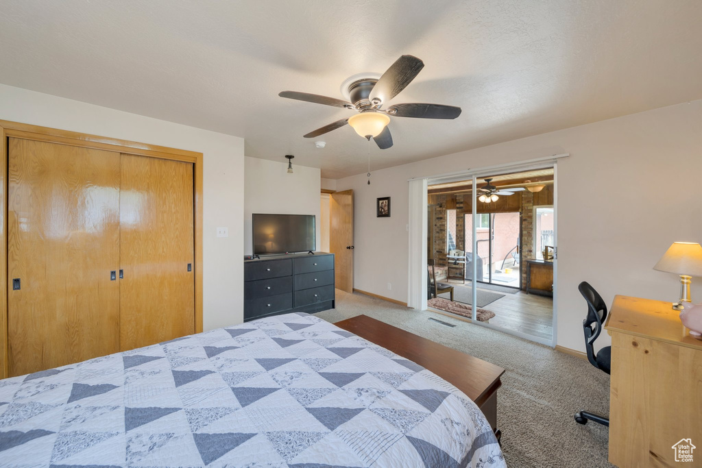 Carpeted bedroom with baseboards, a ceiling fan, and a closet