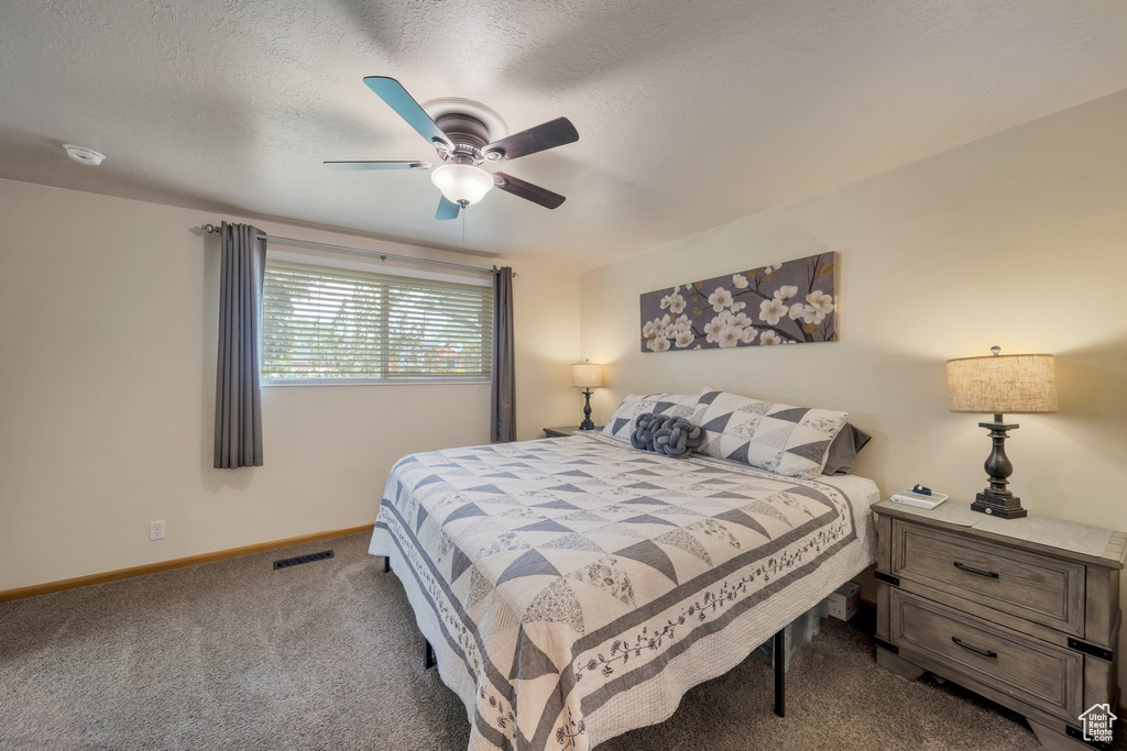 Bedroom featuring carpet flooring, baseboards, and ceiling fan