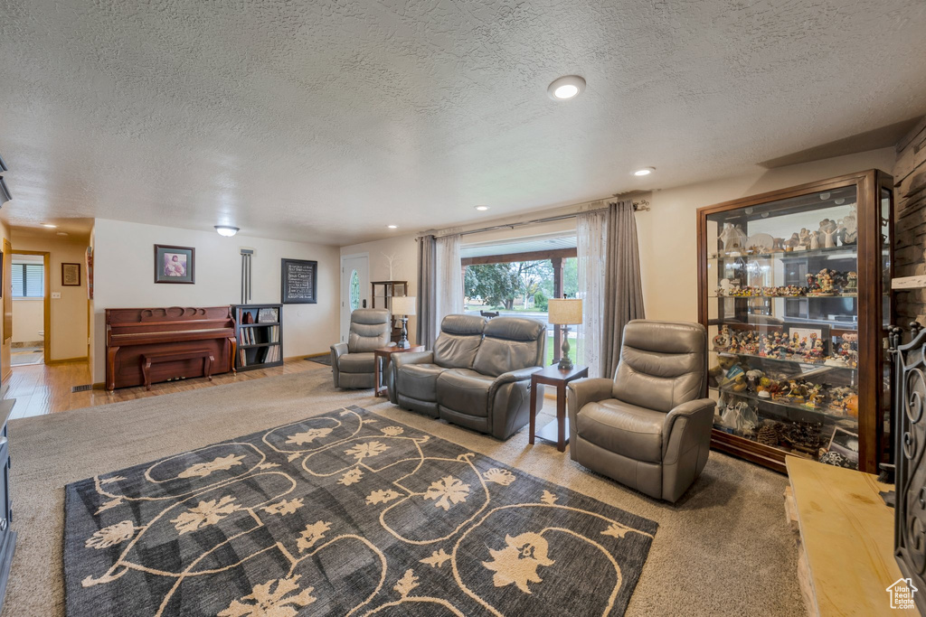 Living room featuring a textured ceiling and recessed lighting