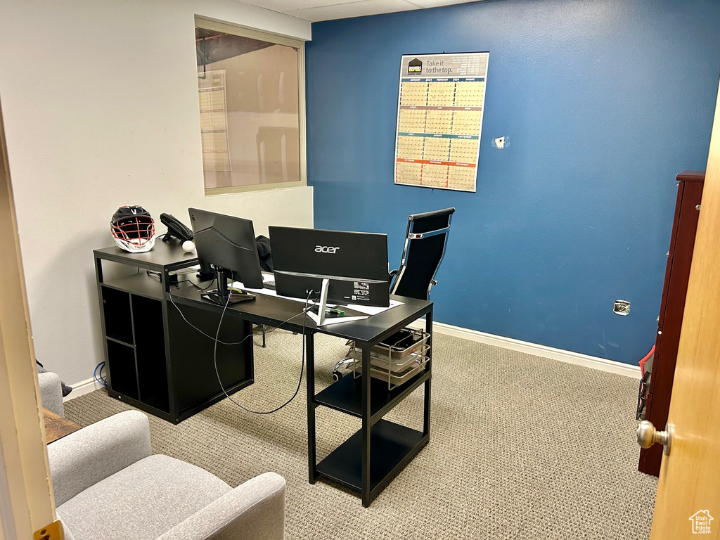Home office with carpet and baseboards