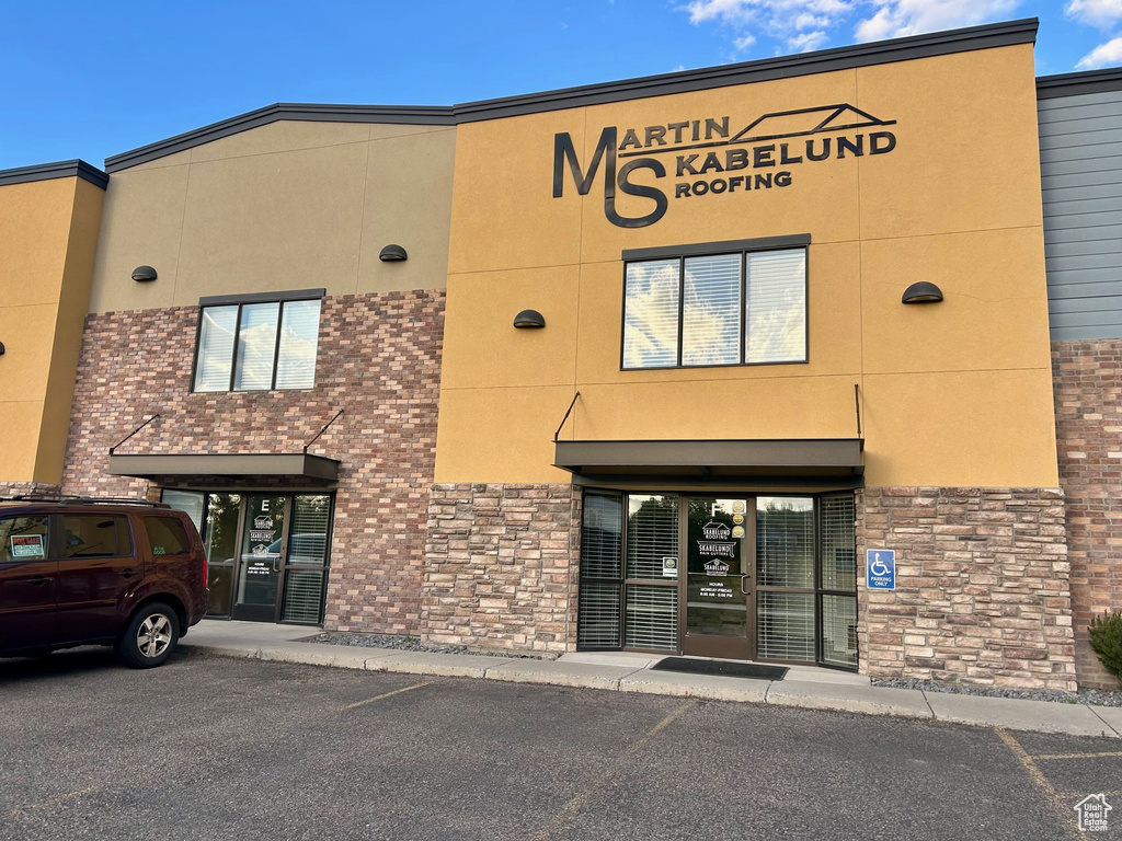 View of commercial location featuring uncovered parking