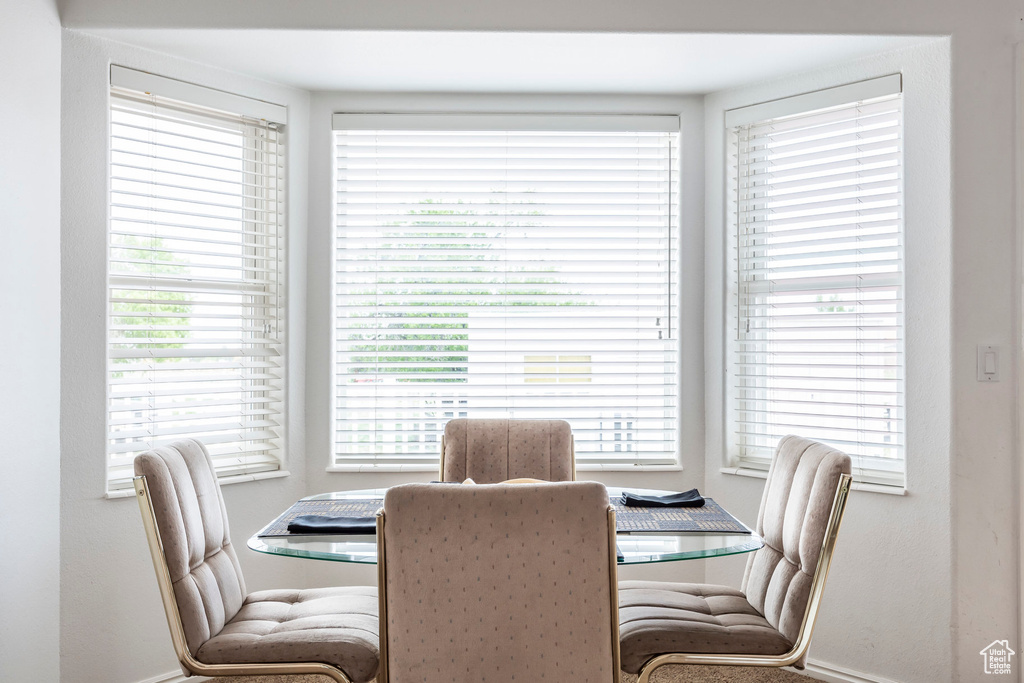 Dining area featuring baseboards and a desk