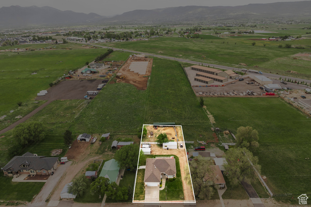 View of rural area featuring a mountain backdrop and property boundaries highlighted