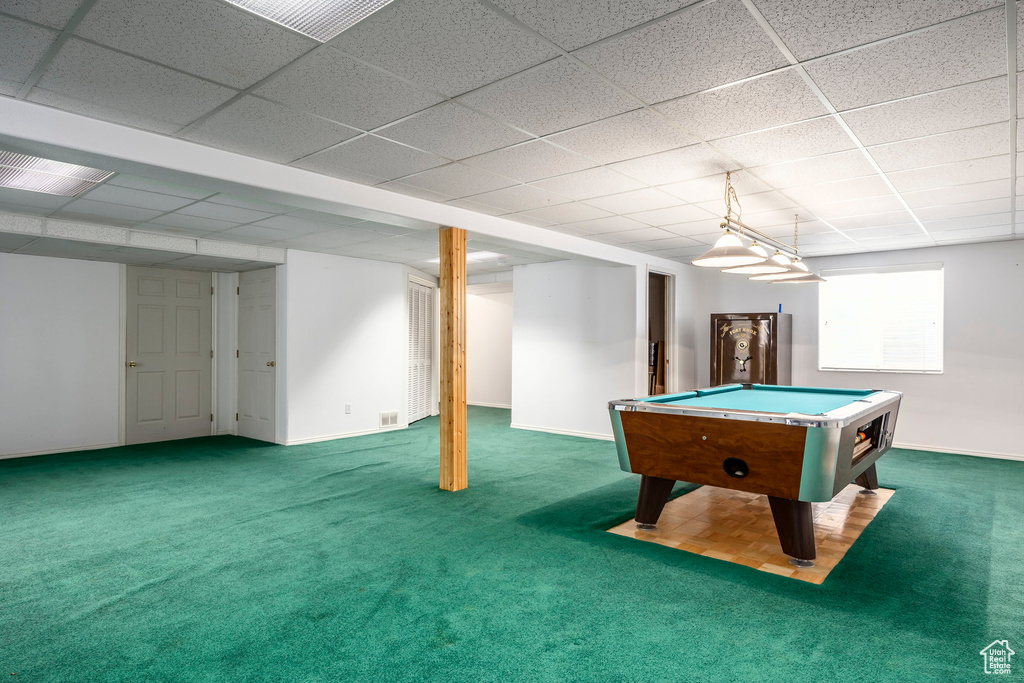 Rec room with carpet floors, billiards, a paneled ceiling, and baseboards