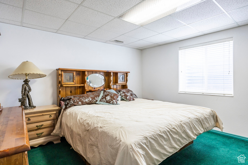 Carpeted bedroom featuring a paneled ceiling