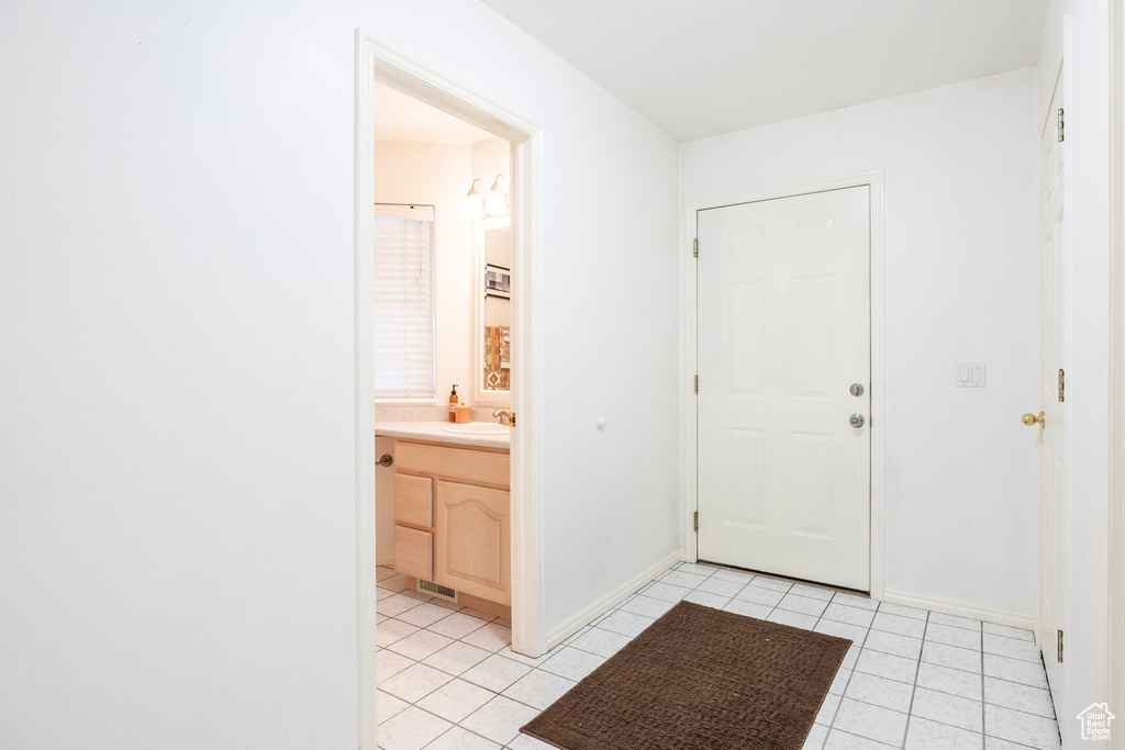 Entryway featuring light tile patterned floors and baseboards