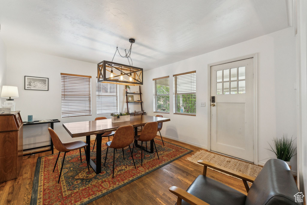 Dining room featuring wood finished floors and a chandelier