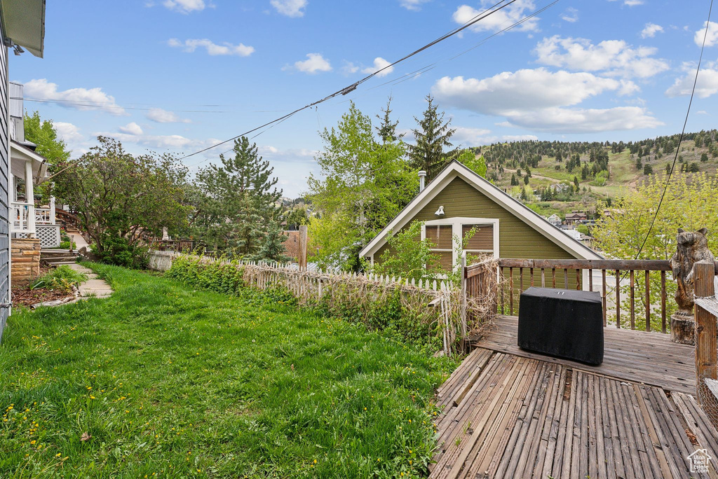 View of yard with a wooden deck