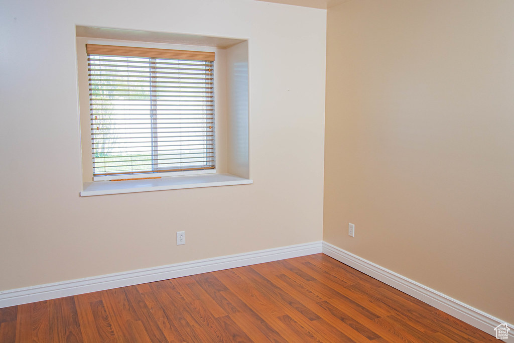 Unfurnished room featuring baseboards and wood finished floors
